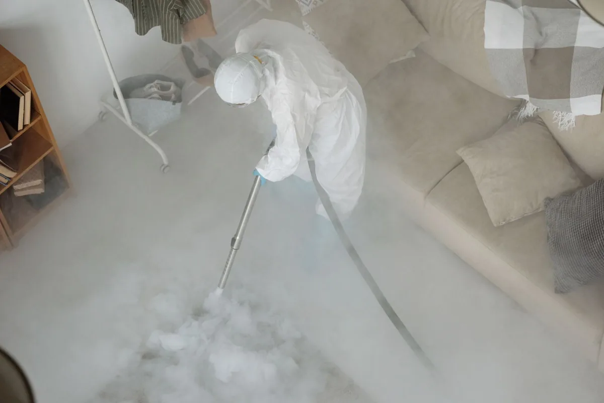 Biohazard cleanup technician in protective equipment, Concourse / Concourse Village, New York, NY